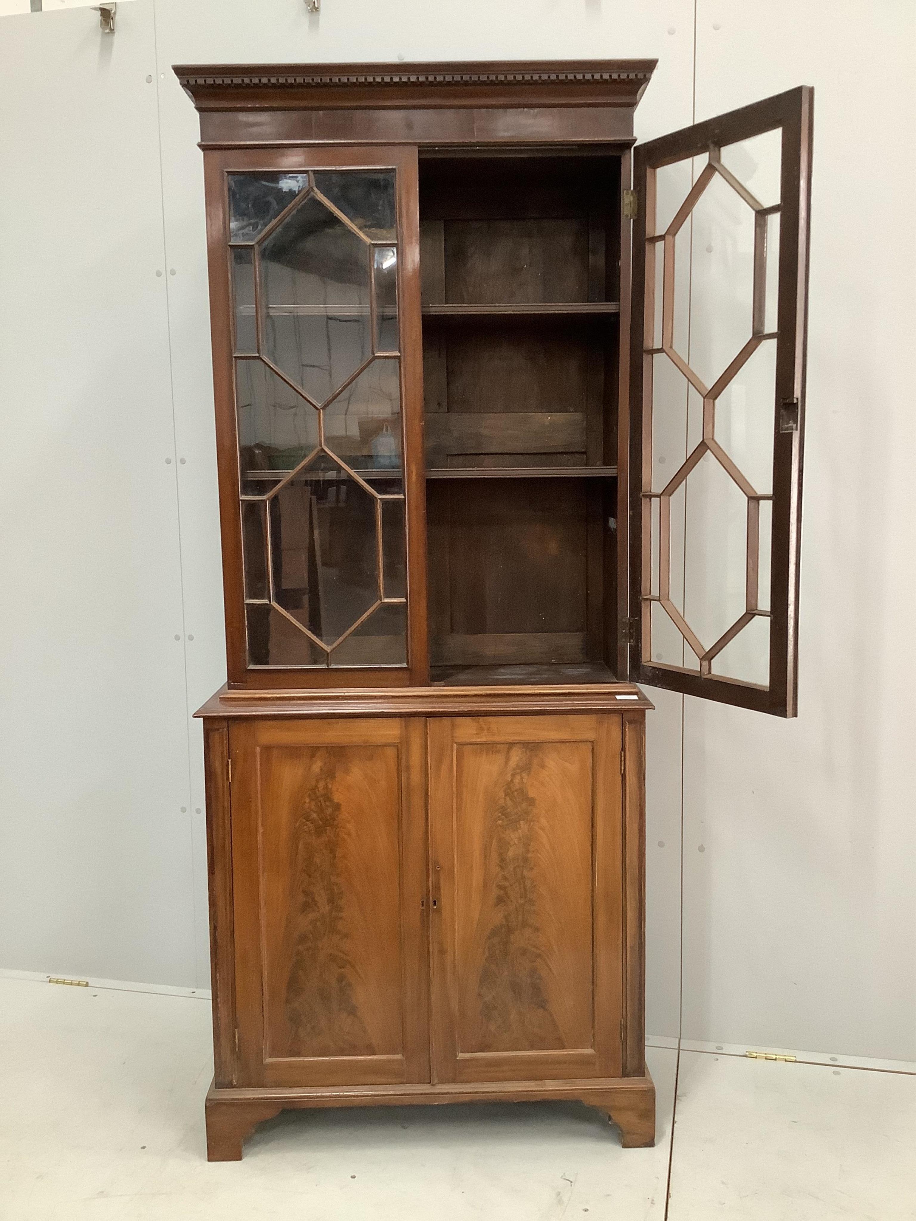 A George III style mahogany bookcase cupboard, width 86cm, 36cm, height 203cm. Condition - fair